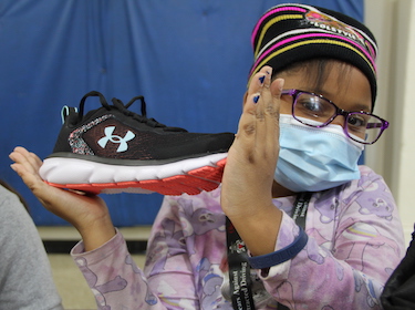  Student holding up shoes